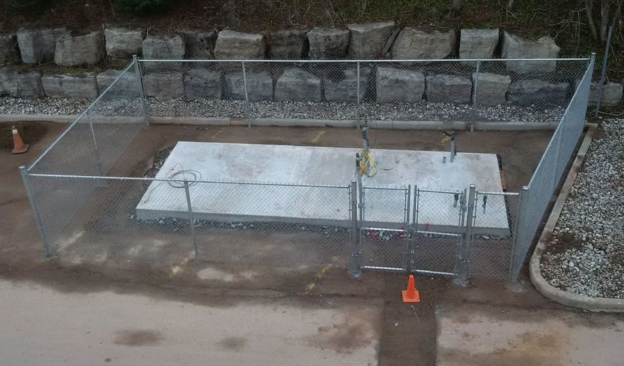 Fenced Concrete Pad for battery and gas generator at Burlington DC Microgrid project